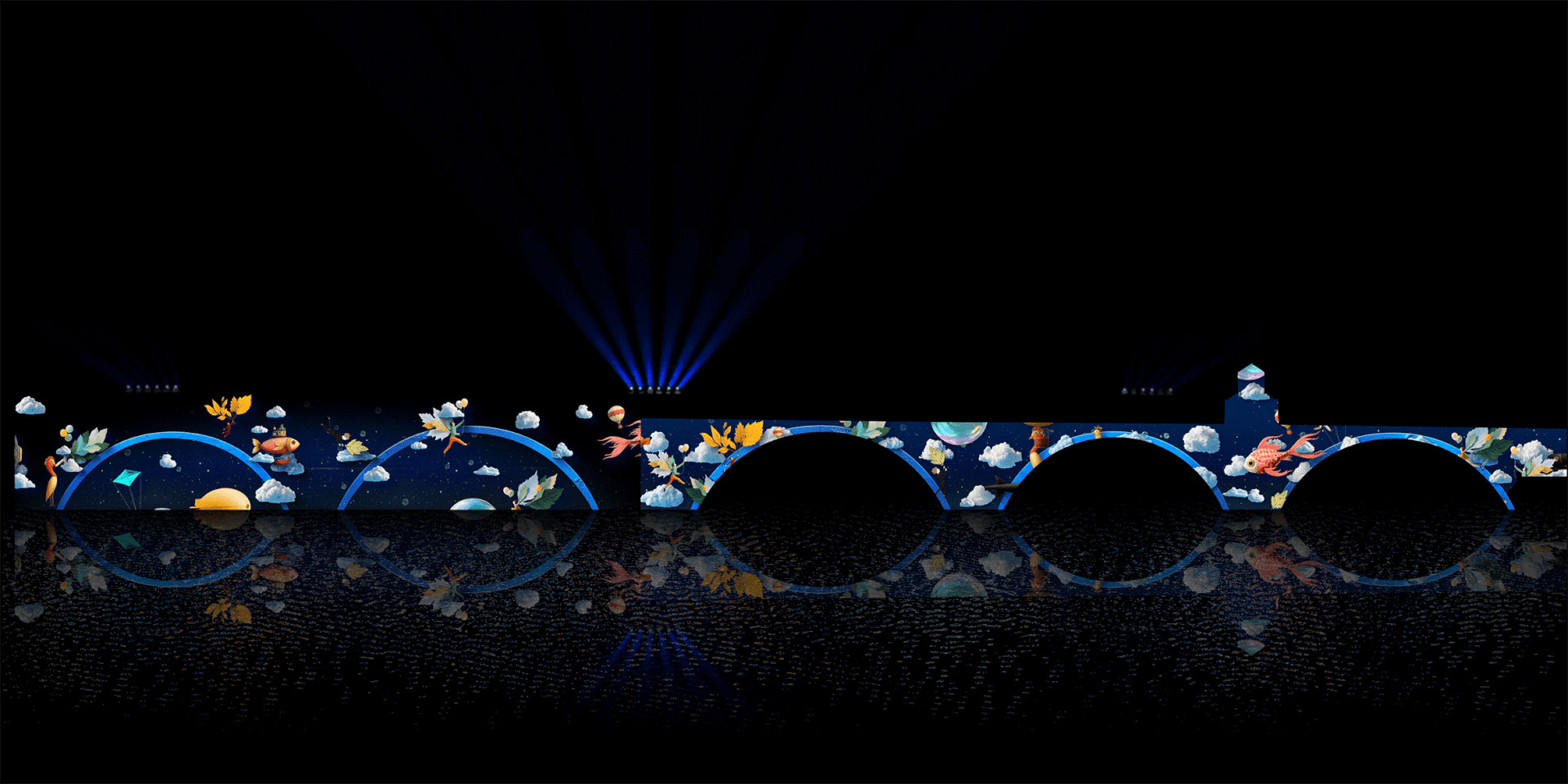 Nighttime photo of a bridge with many arches. Images of clouds, fish, flowers and other motifs are projected on it.