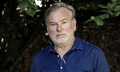 Middle-aged white man with a white beard wearing a blue shirt