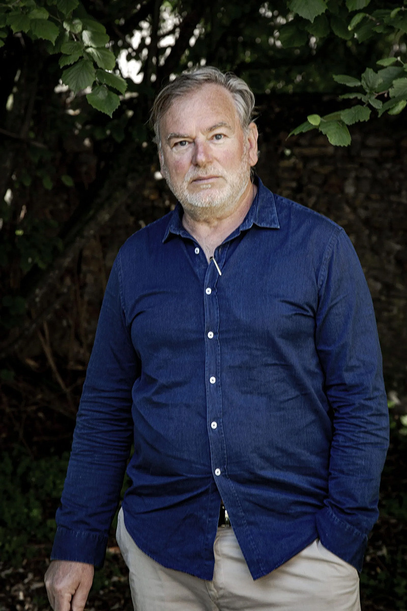 Middle-aged white man with a white beard wearing a blue button-down shirt