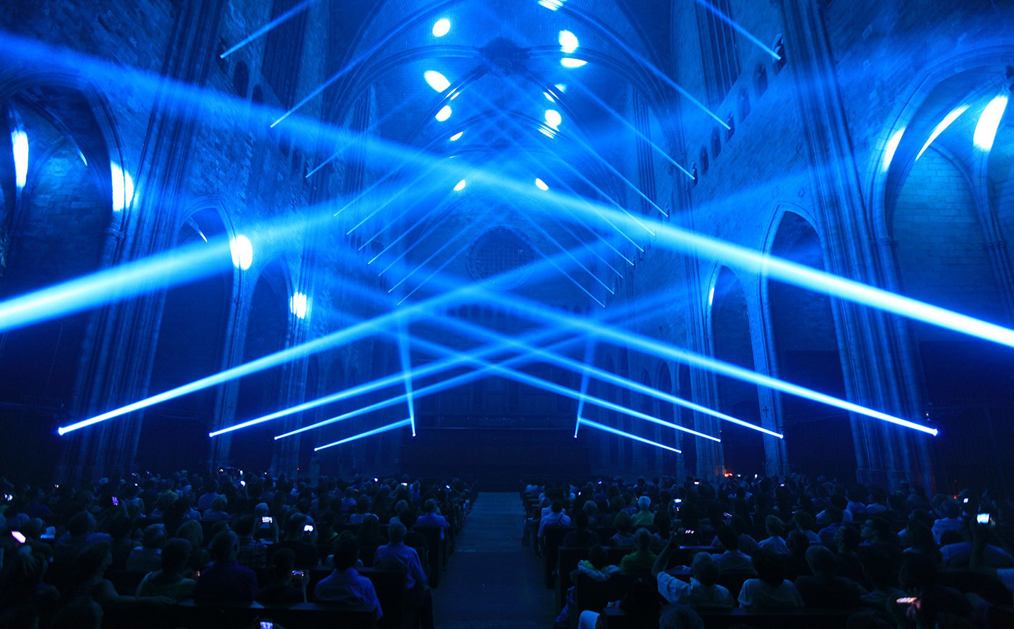 Interior of a cathedral criss-crossed with blue beams of light