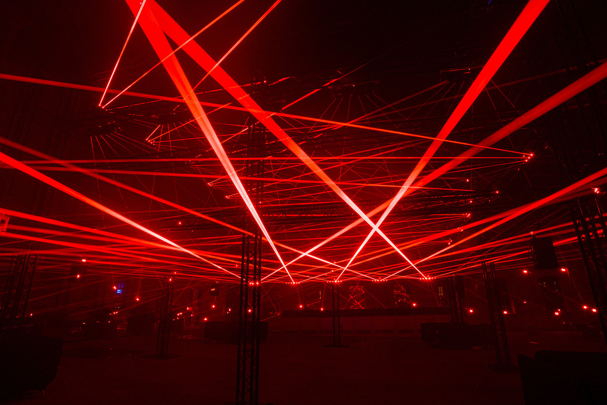 Interior of a warehouse cross-crossed with red beams of light.